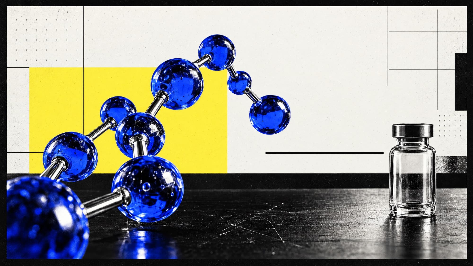 A blue molecular model beside a glass vial on a black bench
